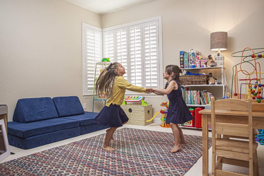 Choose Polywood shutters for durable, kid-friendly great room window treatments in Minneapolis. Polywood shutters on multiple windows in a sitting area