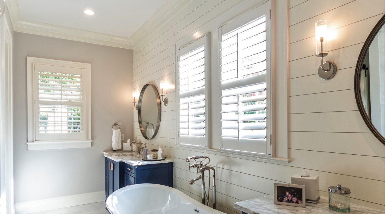 Minneapolis bathroom with white plantation shutters.