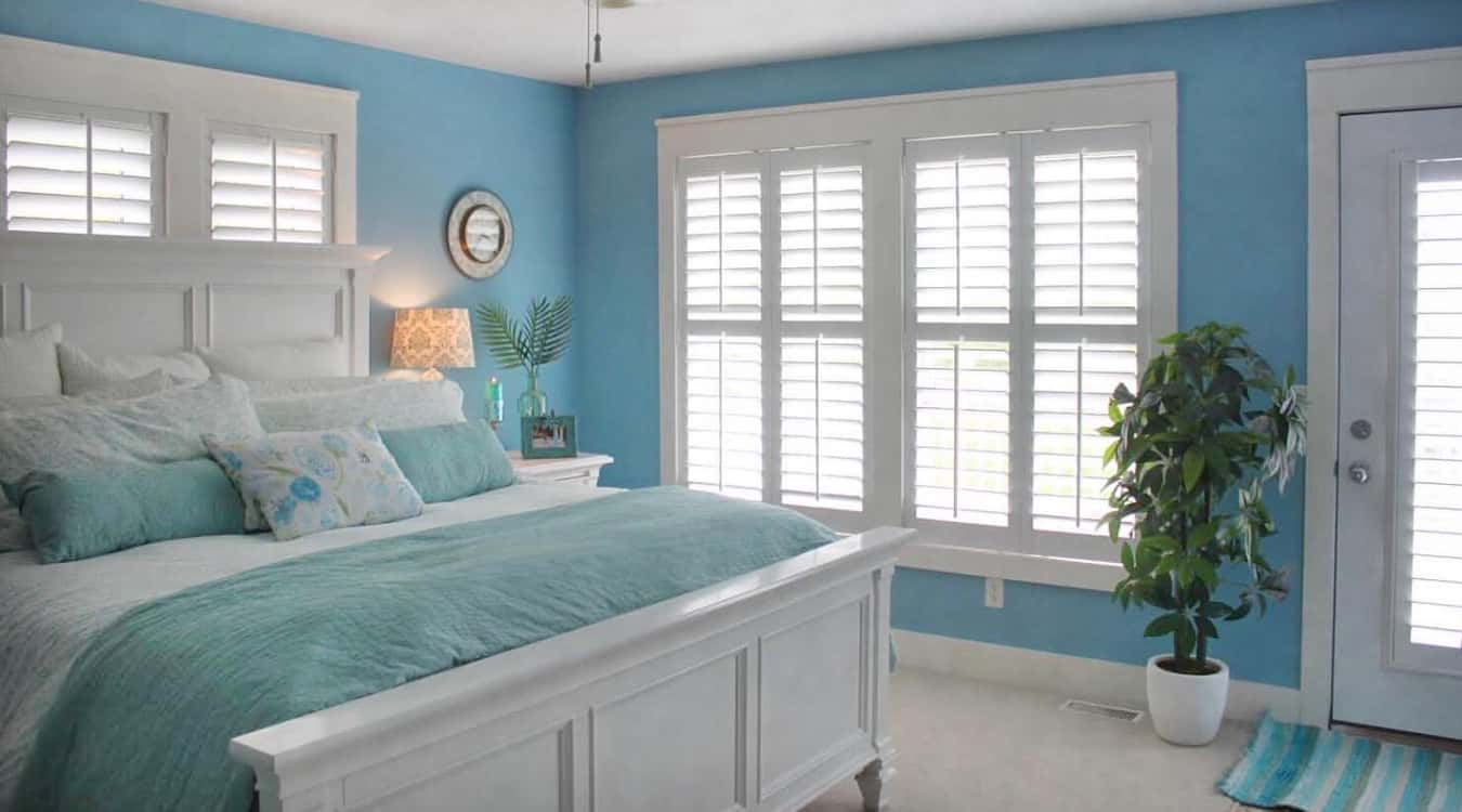 Blue bedroom with interior shutters