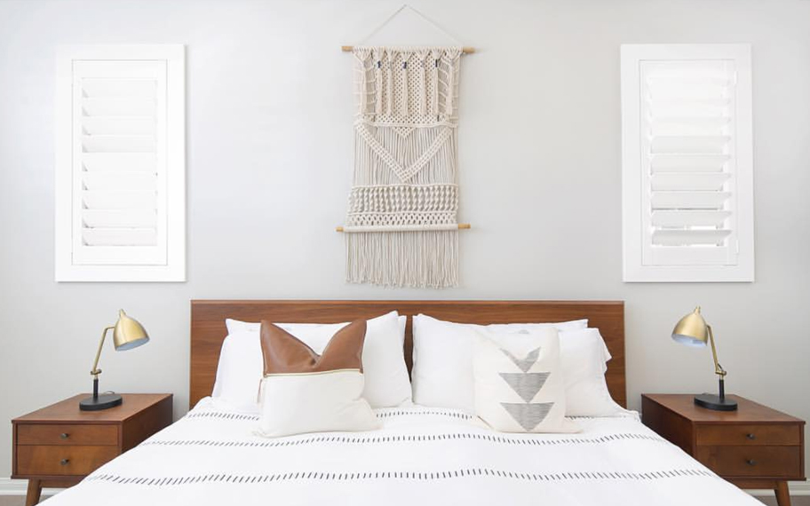 Custom-fitted louvered shutters provide excellent nighttime privacy in Minneapolis. Photo Credit: Audrey Crisp Louvered shutters in a bedroom.