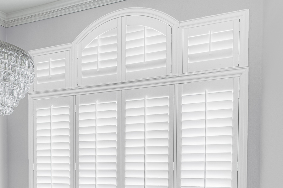 Customize your Palladian windows with white Polywood shutters in Minneapolis. White Polywood Palladian windows in a dining room.