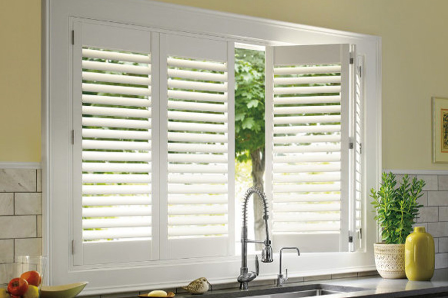 Polywood shutters are built to withstand the test of time in Minneapolis. White Polywood shutters above a kitchen sink.