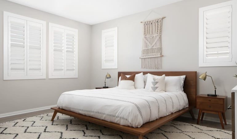 Open shutter louvers will help any Minneapolis room feel larger. Plantation shutters in a model home bedroom.