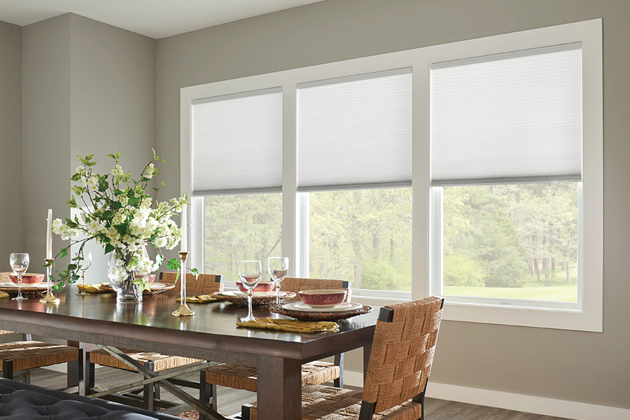 Cellular shades give your windows texture and energy efficiency. White cellular shades on dining room windows