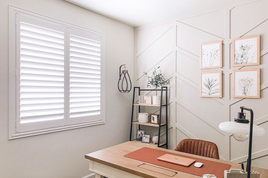 Polywood shutters give you maximum control over natural light in your Minneapolis home. Photo Credit: @OurLakepoint Farmhouse  White and off-white farmhouse style office with natural light from polywood shutters.