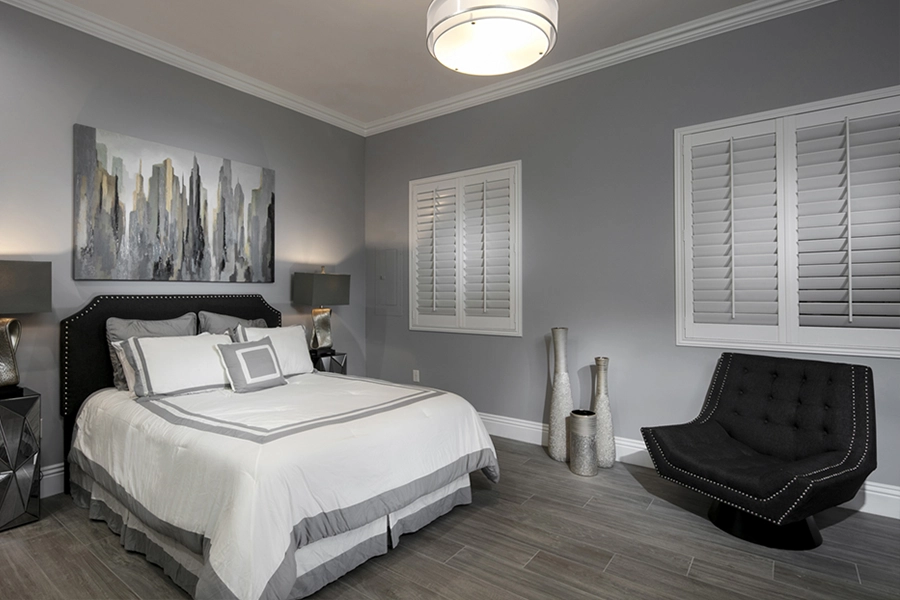 Close your custom Polywood shutters to beat the heat and keep your Minneapolis bedroom cool. White Polywood shutters on bedroom windows